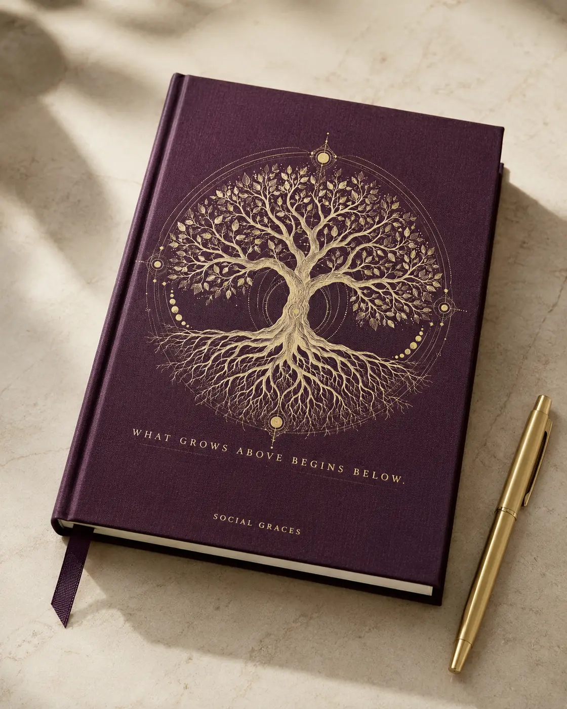 Deep plum Social Graces Tree of Life journal with the words What grows above begins below